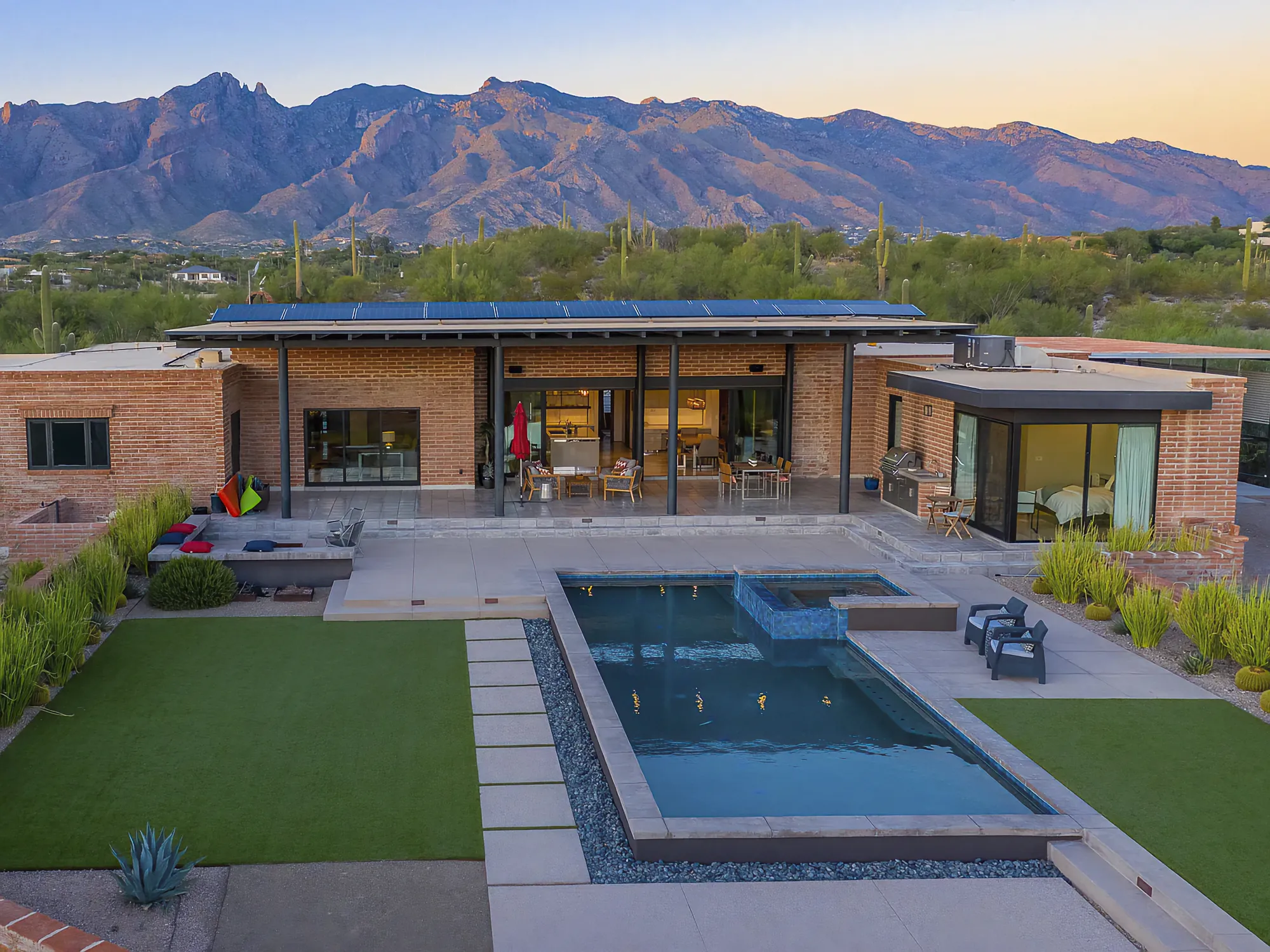 Custom home at Camino Antonio in the Catalina Foothills, burnt adobe and steel with a pool and mountain outlook